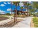 A landscaped community park features a ramada surrounded by towering palm trees at 10352 E Sebring Ave, Mesa, AZ 85212