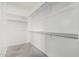 Spacious walk-in closet features built-in shelving and clothing rods with carpeted floors at 10352 E Sebring Ave, Mesa, AZ 85212