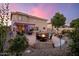 Inviting backyard featuring a pool, fire pit, and covered patio at 10617 W Daley Ln, Peoria, AZ 85383