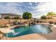 Backyard pool with a rock waterfall, slide, lounge chairs, and covered patio for relaxing and entertaining at 10617 W Daley Ln, Peoria, AZ 85383