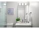 Bright bathroom featuring a vanity with black hardware, a decorative plant, and crisp white towels at 10617 W Daley Ln, Peoria, AZ 85383