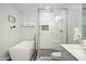Stylish bathroom featuring a soaking tub, glass enclosed shower with marble tile and geometric flooring at 10617 W Daley Ln, Peoria, AZ 85383