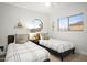 Charming bedroom featuring twin beds with neutral accents, unique window and lots of natural light at 10617 W Daley Ln, Peoria, AZ 85383