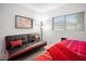Cozy bedroom featuring a futon, artwork, and natural light from the window at 10617 W Daley Ln, Peoria, AZ 85383