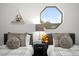 Charming bedroom featuring twin beds with neutral accents, unique window and lots of natural light at 10617 W Daley Ln, Peoria, AZ 85383