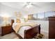 Bright bedroom with wood furniture, neutral paint, plush rug and lots of natural light at 10617 W Daley Ln, Peoria, AZ 85383