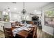 Open-concept dining area with hardwood floors, modern lighting, and seamless access to the living room at 10617 W Daley Ln, Peoria, AZ 85383