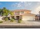 Charming two-story home featuring a tile roof, manicured landscaping, and an attached two-car garage at 10617 W Daley Ln, Peoria, AZ 85383