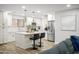 Kitchen featuring a central island with bar stools, stainless steel appliances, and ample cabinet space at 10617 W Daley Ln, Peoria, AZ 85383