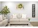 Inviting living room featuring a comfortable couch with pillows and a decorative wreath accenting the wall at 10617 W Daley Ln, Peoria, AZ 85383