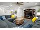 Cozy living room with comfortable seating, an entertainment center, and a chess set on a coffee table at 10617 W Daley Ln, Peoria, AZ 85383