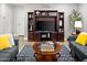Comfortable living space featuring an entertainment center, a cozy seating arrangement, and modern flooring at 10617 W Daley Ln, Peoria, AZ 85383