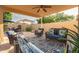 Spacious patio with comfortable lounge furniture and a patterned rug, perfect for outdoor entertaining at 10617 W Daley Ln, Peoria, AZ 85383