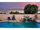 Tranquil pool with a natural rock waterfall feature and lounge chairs at 10617 W Daley Ln, Peoria, AZ 85383