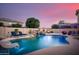 Beautiful pool with rock waterfall feature, slide, and lounge chairs, perfect for relaxing and enjoying the outdoors at 10617 W Daley Ln, Peoria, AZ 85383