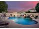 Backyard pool with waterfall, slide, and comfortable lounge chairs at 10617 W Daley Ln, Peoria, AZ 85383