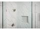 Beautiful glass-enclosed shower with marble tile and a built-in shelf at 10617 W Daley Ln, Peoria, AZ 85383