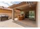 A spacious covered patio area with outdoor dining set and a grill, ideal for backyard gatherings and barbecues at 10738 W Rowel Rd, Peoria, AZ 85383
