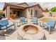 Charming backyard features a cozy fire pit area with comfortable seating, perfect for enjoying the outdoors at 10738 W Rowel Rd, Peoria, AZ 85383