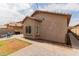 A cozy backyard featuring a small patch of grass and a patio with outdoor seating under string lights at 10738 W Rowel Rd, Peoria, AZ 85383