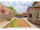 Landscaped backyard with a seating area, brick pavers, and a block wall, creating a private outdoor space at 10738 W Rowel Rd, Peoria, AZ 85383