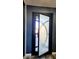 A stylish front door with unique frosted glass and dark trim detail adds a modern touch to the home's entry at 10738 W Rowel Rd, Peoria, AZ 85383