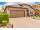 Charming single-story home featuring a tiled roof, neutral stucco, brick driveway, and well-kept bushes at 10738 W Rowel Rd, Peoria, AZ 85383