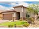 Inviting single-story home with tiled roof, neutral stucco, stone accents, and well-maintained landscaping at 10738 W Rowel Rd, Peoria, AZ 85383