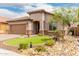 Inviting single-story home with tiled roof, neutral stucco, stone accents, and well-maintained landscaping at 10738 W Rowel Rd, Peoria, AZ 85383