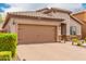 Charming single-story home featuring a tiled roof, neutral stucco, brick driveway, and well-kept bushes at 10738 W Rowel Rd, Peoria, AZ 85383