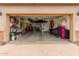 Open garage space with organization, equipment, tools, and storage; kayak on the ceiling at 10738 W Rowel Rd, Peoria, AZ 85383