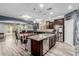 Modern kitchen with large island, stainless appliances, dark wood cabinets and open floorplan at 10738 W Rowel Rd, Peoria, AZ 85383