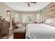 Bright main bedroom features hardwood flooring, windows, ceiling fan, and accent wall at 10738 W Rowel Rd, Peoria, AZ 85383