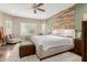 Comfortable main bedroom with accent wall, carpeting, ceiling fan and seating area at 10738 W Rowel Rd, Peoria, AZ 85383