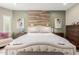 Charming main bedroom with accent wall, hardwood flooring, natural light and ceiling fan at 10738 W Rowel Rd, Peoria, AZ 85383