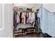 Organized walk-in closet features ample shelving and hanging space for clothes and shoe storage at 10738 W Rowel Rd, Peoria, AZ 85383
