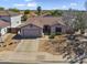 Aerial view of a suburban home with a tiled roof and a well-maintained yard in a quiet neighborhood at 10923 E Flower Ave, Mesa, AZ 85208
