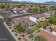 Aerial view of a suburban home with a tiled roof and a well-maintained yard in a quiet neighborhood at 10923 E Flower Ave, Mesa, AZ 85208