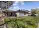 Grassy backyard with a covered patio area, perfect for outdoor relaxation and entertainment at 10923 E Flower Ave, Mesa, AZ 85208
