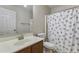 Bathroom featuring a wood vanity, mirror, and a shower with a patterned curtain at 10923 E Flower Ave, Mesa, AZ 85208