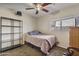 Bedroom with carpet flooring, ceiling fan, and a window for natural light at 10923 E Flower Ave, Mesa, AZ 85208