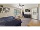 Bedroom with carpet, storage, plush bed, ceiling fan and ensuite bathroom at 10923 E Flower Ave, Mesa, AZ 85208