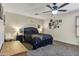 Spacious bedroom with ceiling fan, stylish decor, and plush bed at 10923 E Flower Ave, Mesa, AZ 85208