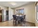 Charming dining area featuring a square table, four chairs, and a window view at 10923 E Flower Ave, Mesa, AZ 85208