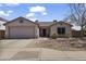 Charming single-story home with a well-maintained front yard and a two-car garage at 10923 E Flower Ave, Mesa, AZ 85208