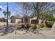 Single-story home with desert landscaping in front, including drought-tolerant trees and bushes at 10923 E Flower Ave, Mesa, AZ 85208