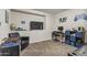 Entertainment room with TV, desk, and foosball table, perfect for leisure and play at 10923 E Flower Ave, Mesa, AZ 85208