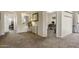 Inviting hallway with neutral carpet and tasteful decor leading to a cozy room with 'PLAY' sign at 10923 E Flower Ave, Mesa, AZ 85208