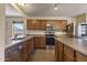 Well-equipped kitchen with stainless steel appliances and light wood cabinets at 10923 E Flower Ave, Mesa, AZ 85208