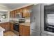 This bright kitchen is equipped with stainless steel appliances and wood cabinets at 10923 E Flower Ave, Mesa, AZ 85208